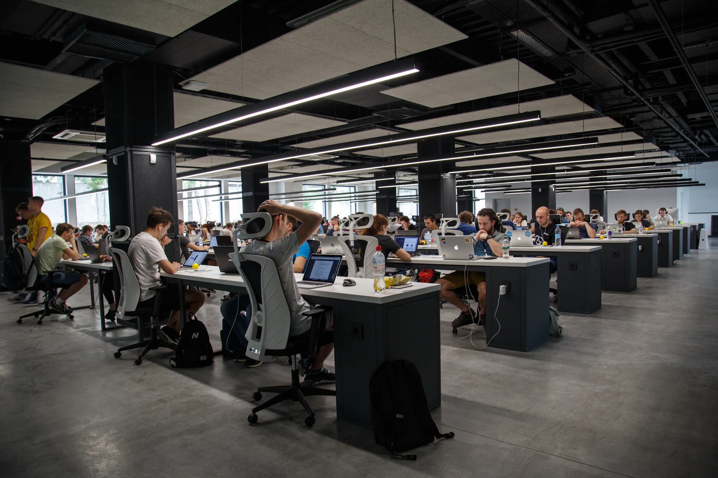 An engineering floor with developers working at desks and screens