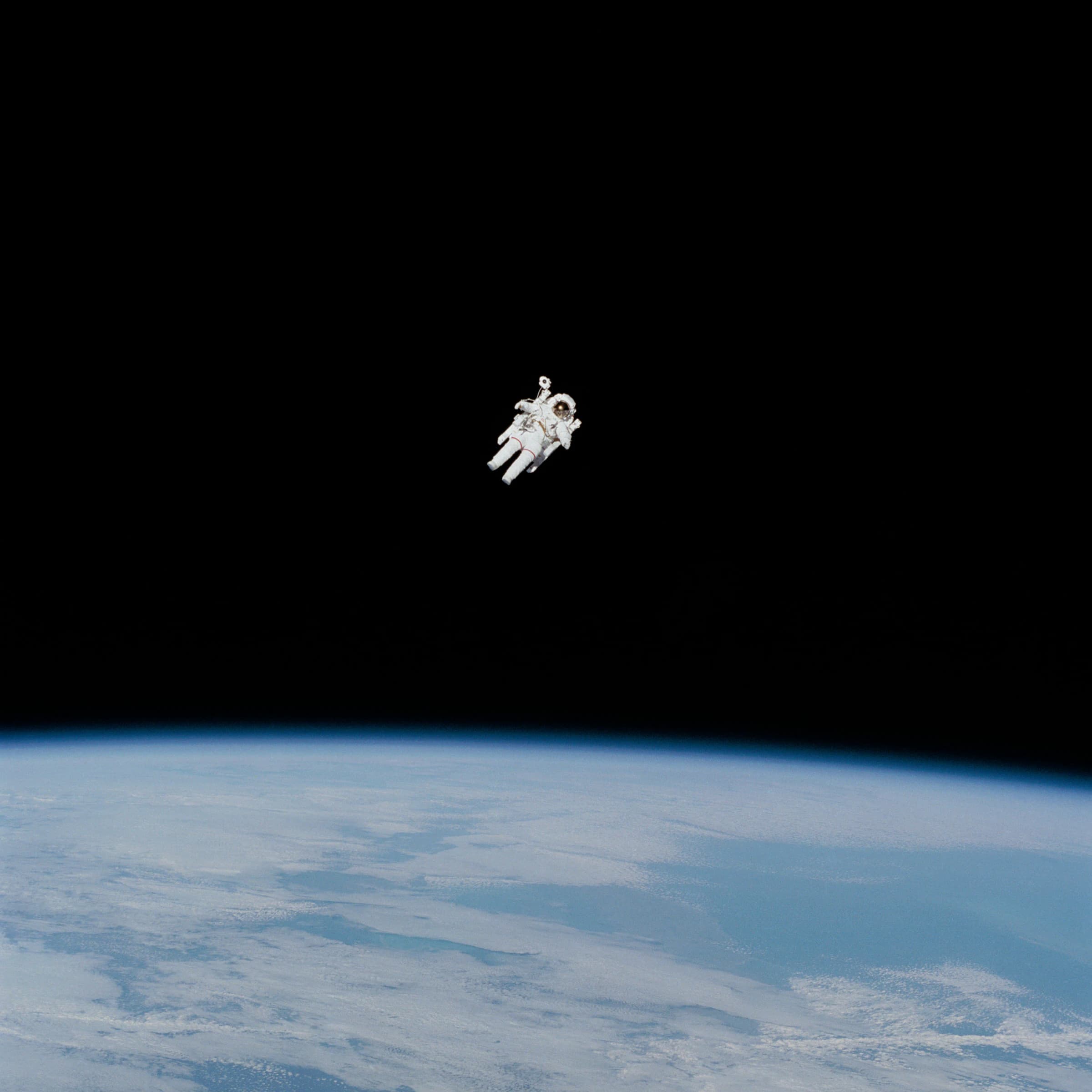 An untethered spacewalk against the black, Earth's limb far below
