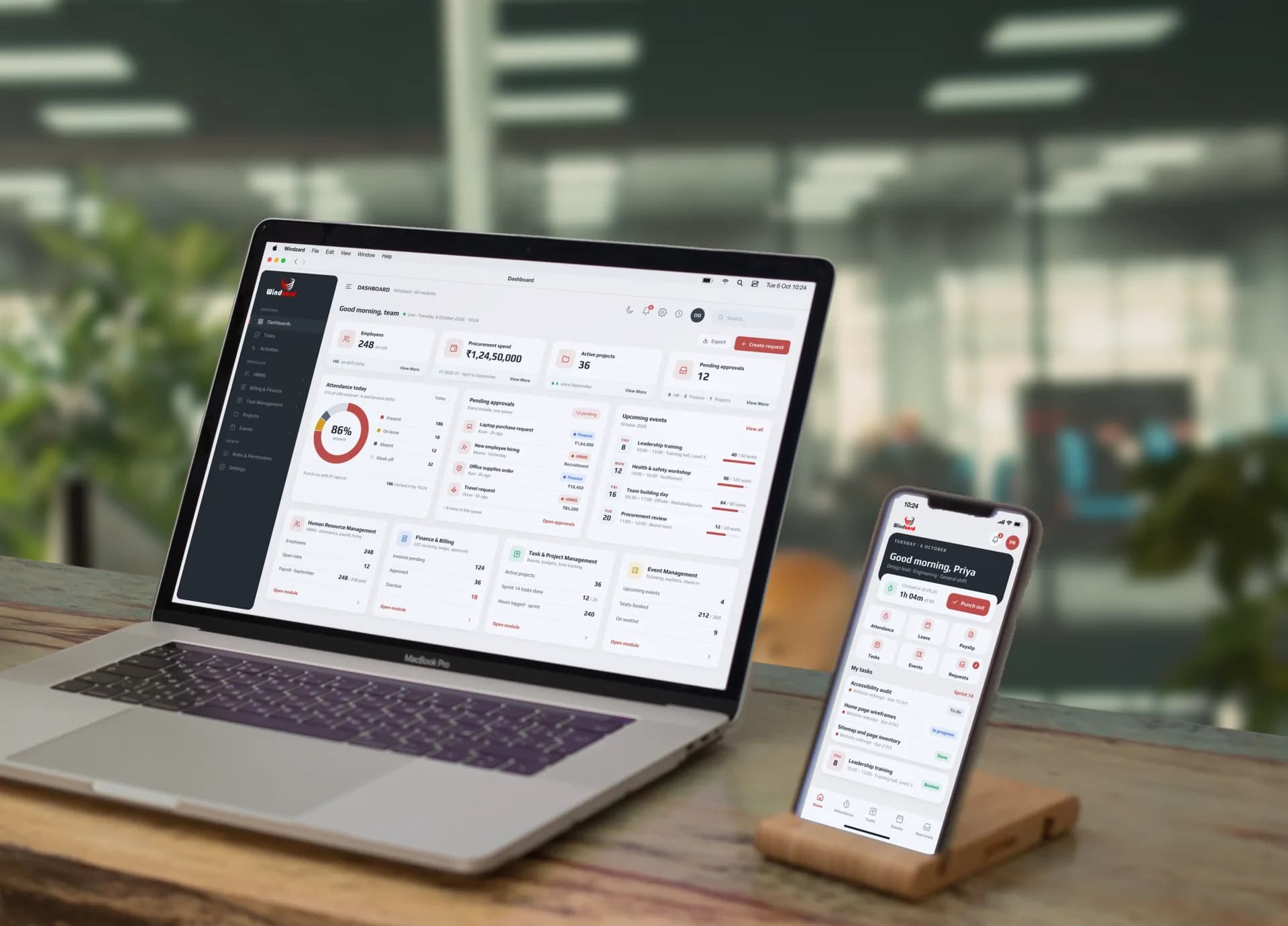 The Windzard platform we built, on a MacBook Pro and an iPhone on a desk in an open-plan office