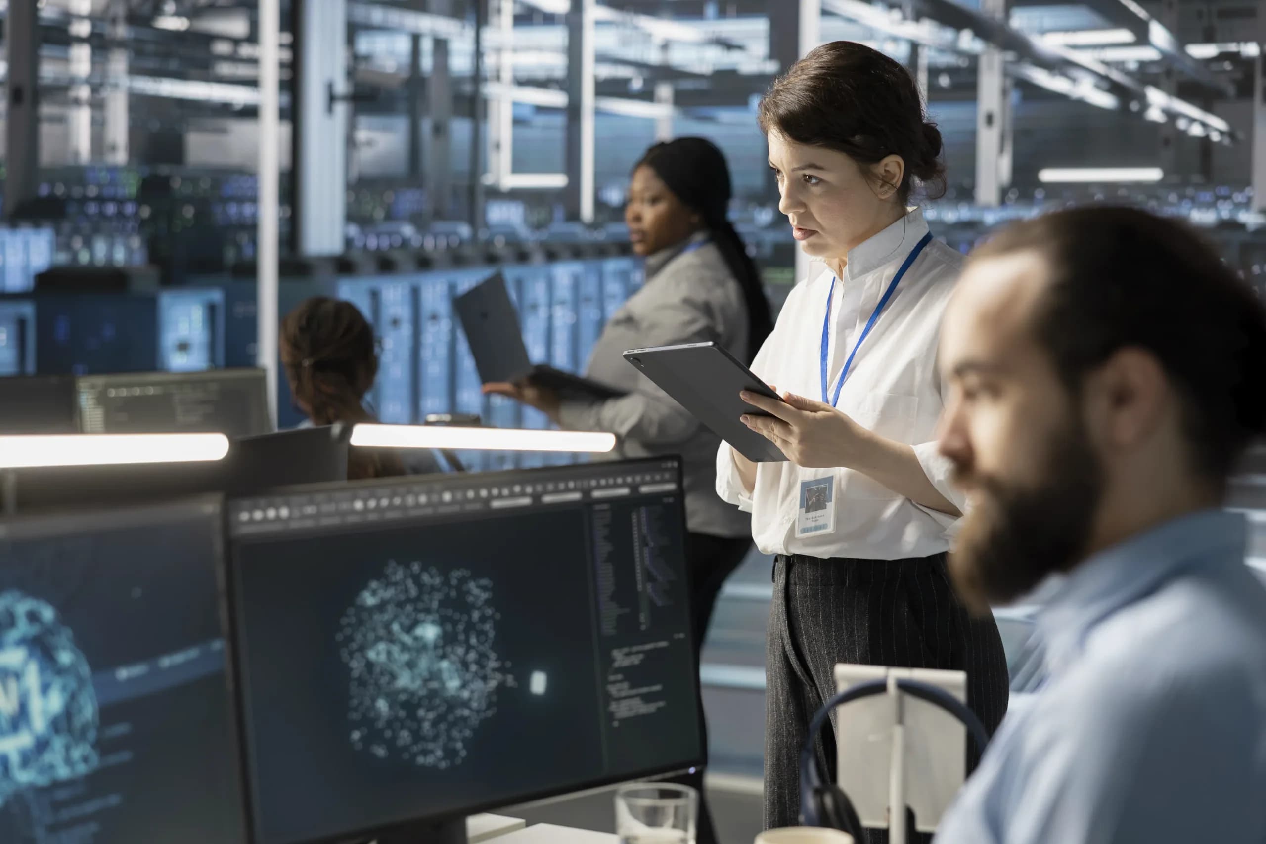 Engineers monitoring model workloads on a data-centre floor