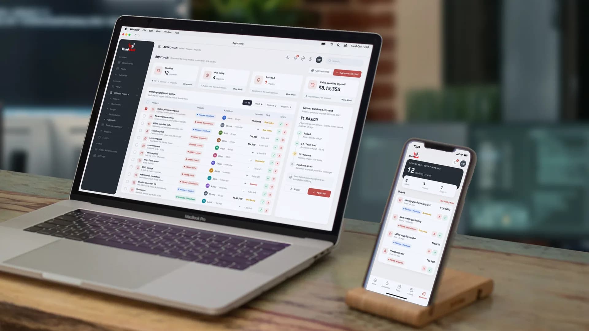 The pending approvals queue of 12 — a laptop purchase request, a new employee hiring, an office supplies order and a travel request among them — each tagged with the module it came from, on a MacBook, with the same queue on the staff app on an iPhone