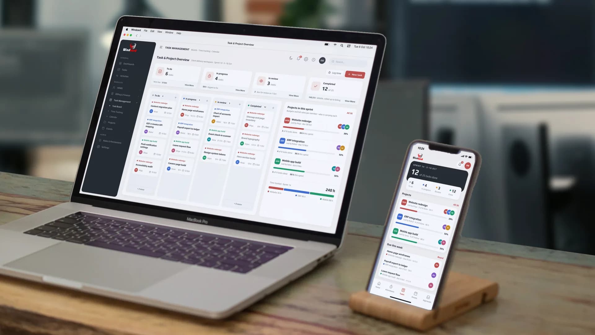 The Task & Project Overview: six to do, four in progress, three in review and twelve completed, across the website redesign, ERP integration and mobile app builds and who is carrying each — on a MacBook, with the sprint on the staff app on an iPhone