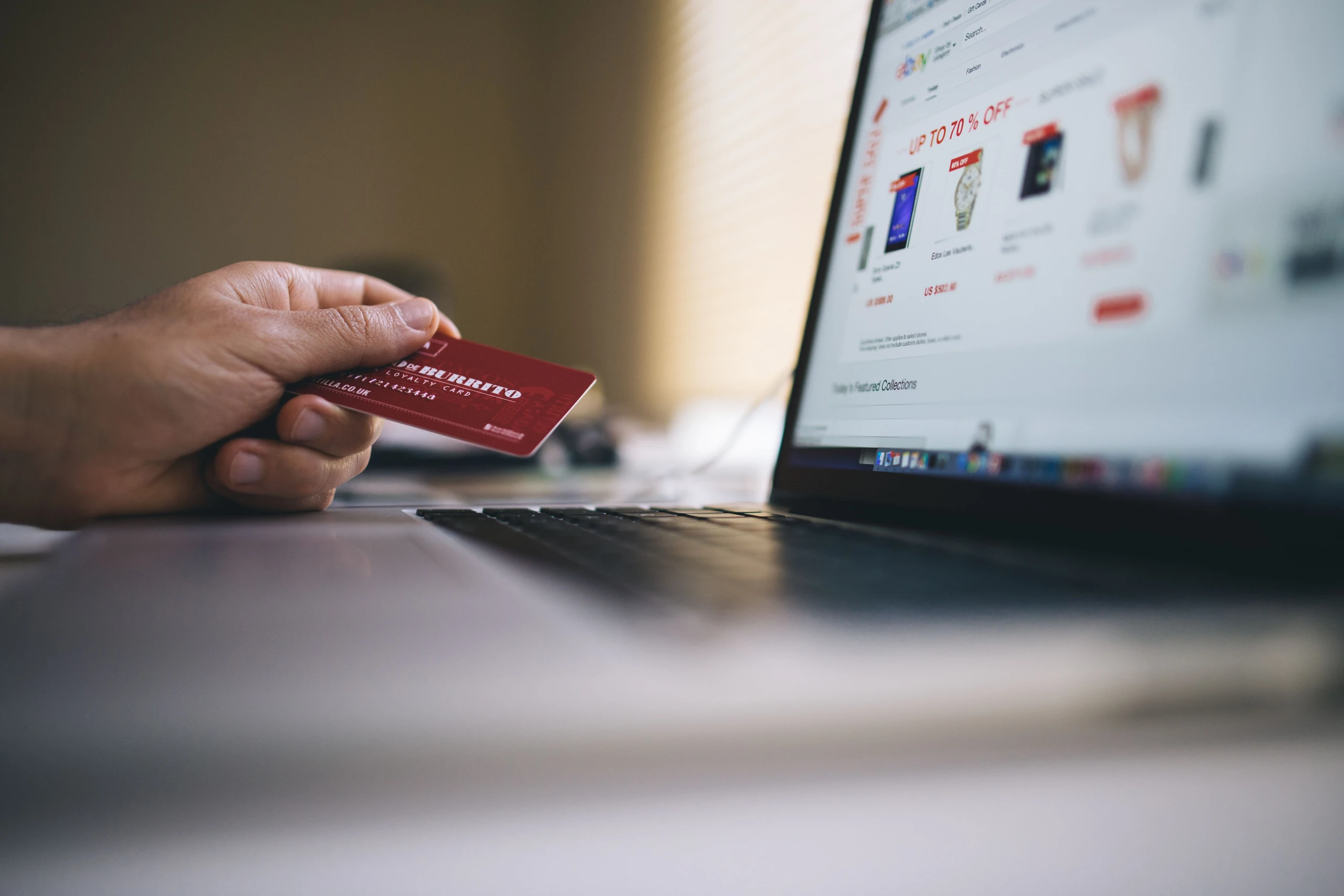 Customer paying by card at an online store checkout on a laptop
