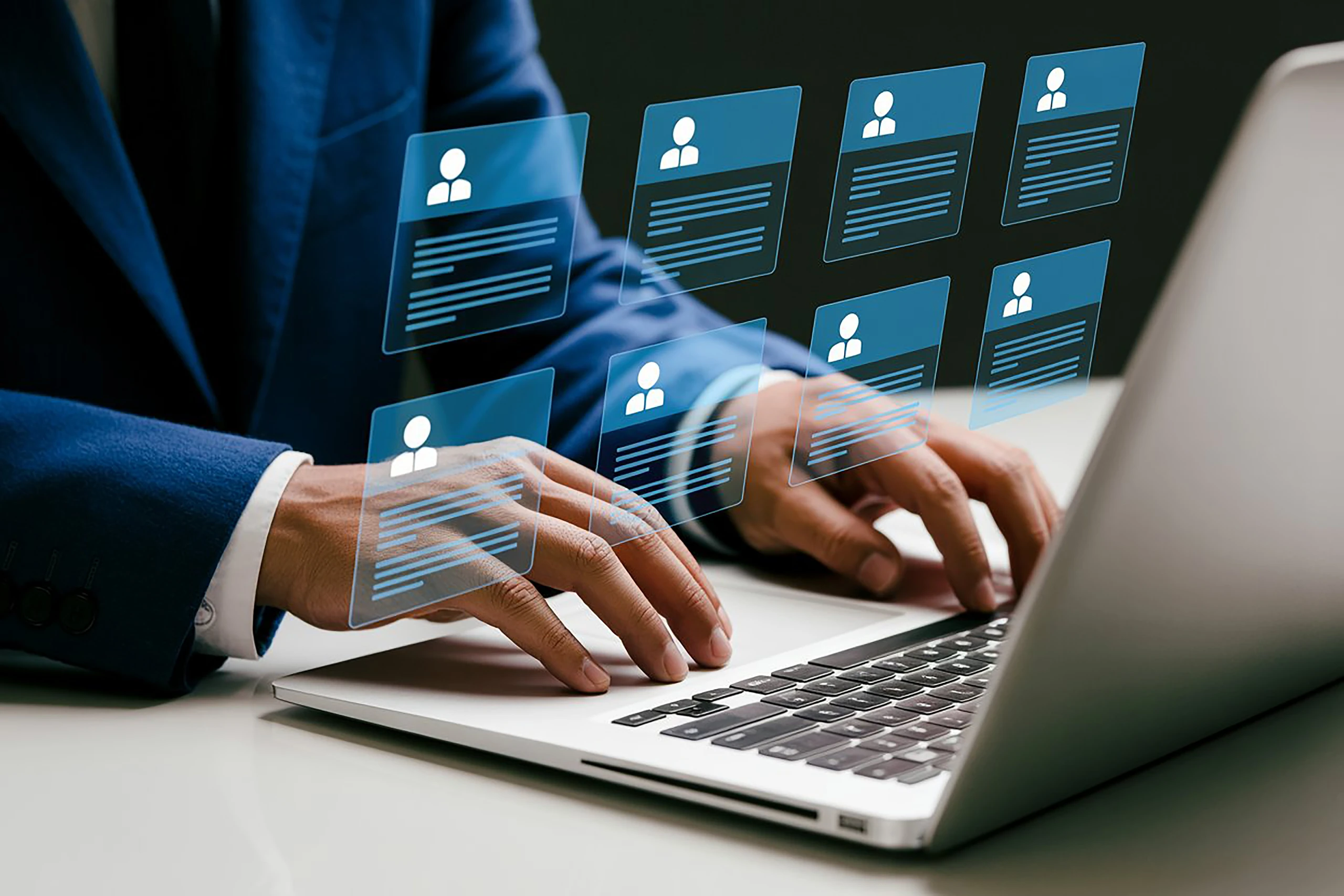 Recruiter working through a set of employee profile records on a laptop